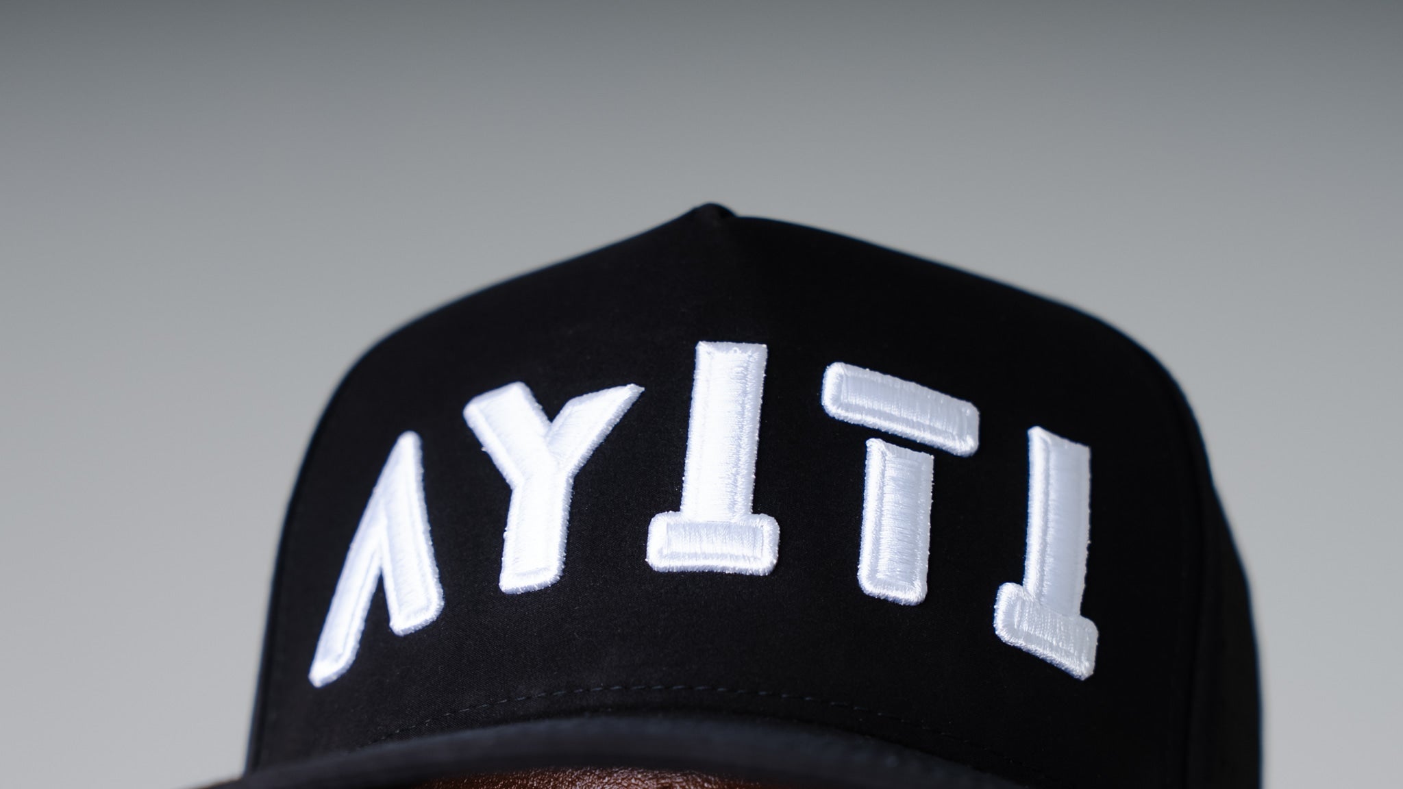 Black cap with white text on a gray background
